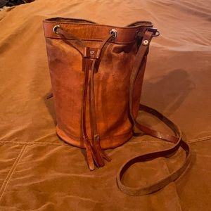 A bucket light brown leather bucket purse
